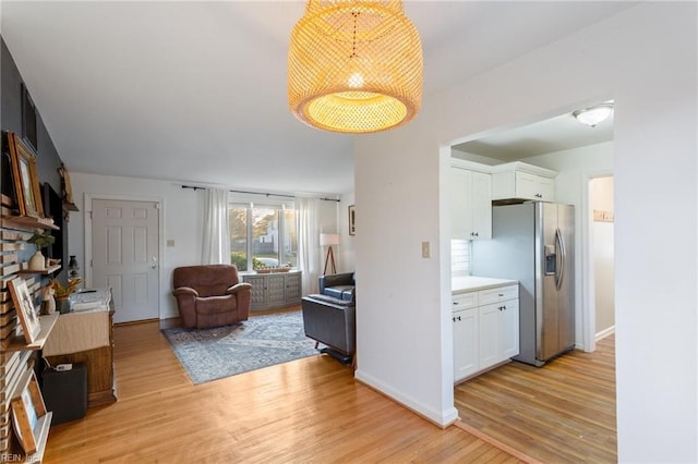 living room featuring baseboards and light wood-style flooring