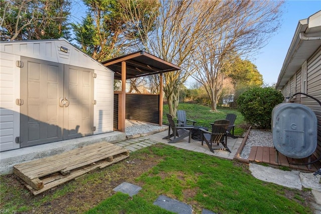 view of yard featuring a patio, an outbuilding, a storage shed, and fence