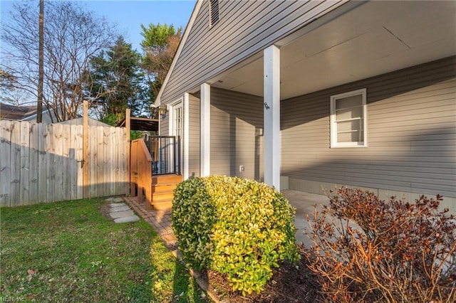 view of property exterior featuring a yard and fence