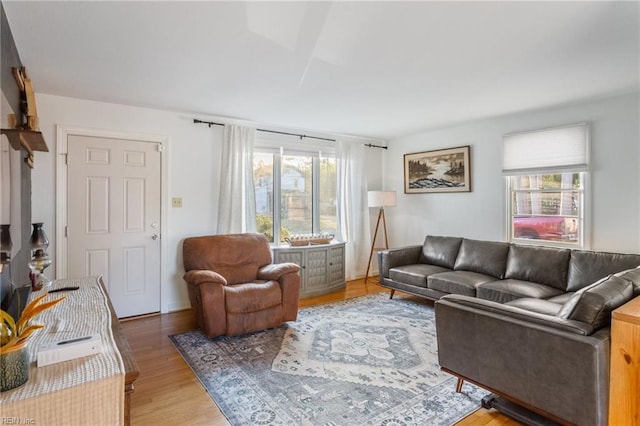 living area with plenty of natural light and light wood-style flooring