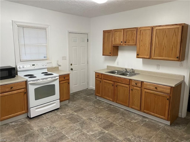 kitchen featuring brown cabinetry, black microwave, white electric range, and a sink