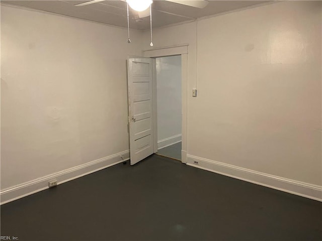 empty room featuring baseboards and a ceiling fan