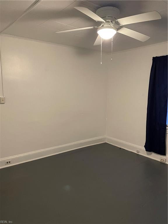 empty room with baseboards and a ceiling fan