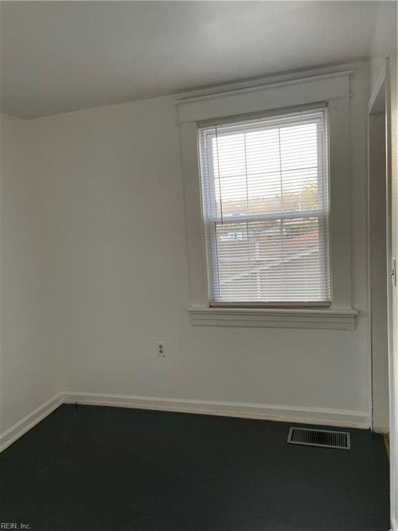 empty room featuring visible vents and baseboards