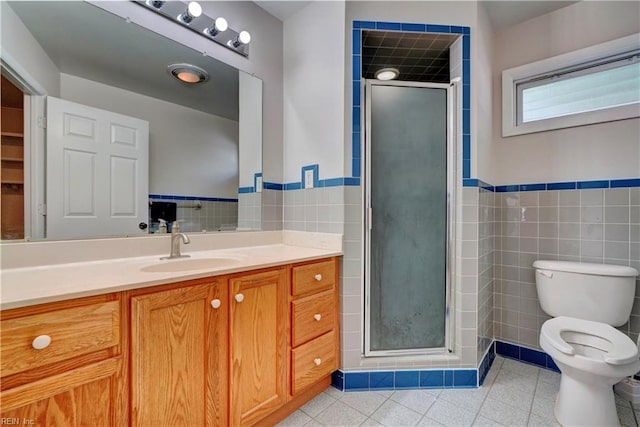 full bath featuring toilet, tile walls, a stall shower, and vanity