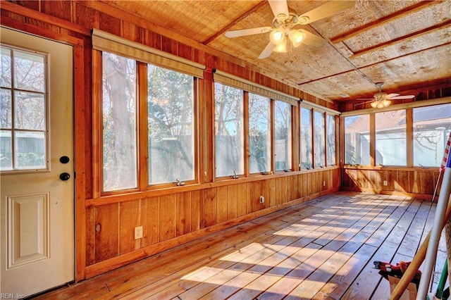 unfurnished sunroom with wood ceiling and ceiling fan