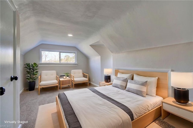 bedroom featuring vaulted ceiling, baseboards, and carpet floors