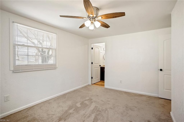 unfurnished bedroom with baseboards, carpet, and a ceiling fan