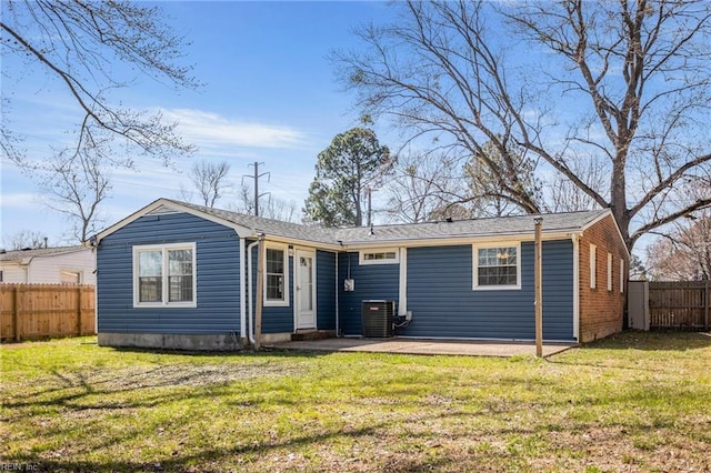 back of house featuring central AC unit, a lawn, a patio, and fence