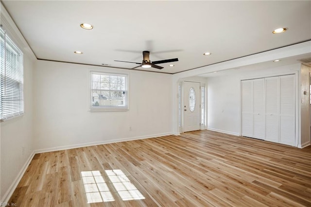 interior space with a ceiling fan, baseboards, light wood finished floors, recessed lighting, and ornamental molding