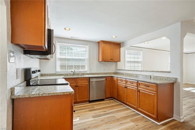 kitchen featuring light wood-type flooring, stainless steel dishwasher, brown cabinetry, electric range, and a sink