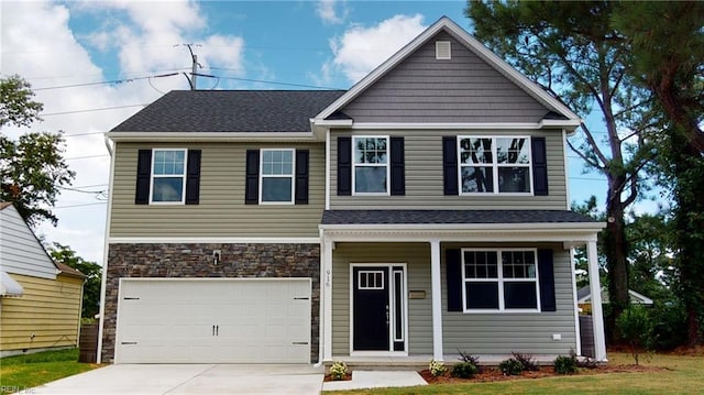 view of front of home featuring roof with shingles, an attached garage, covered porch, concrete driveway, and stone siding