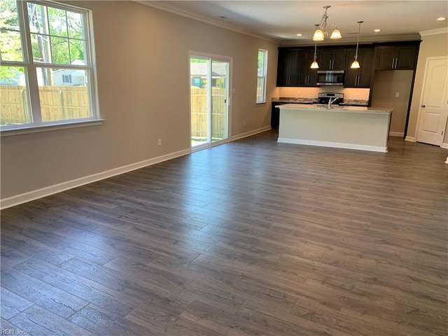 kitchen featuring open floor plan, appliances with stainless steel finishes, crown molding, and dark wood-style flooring