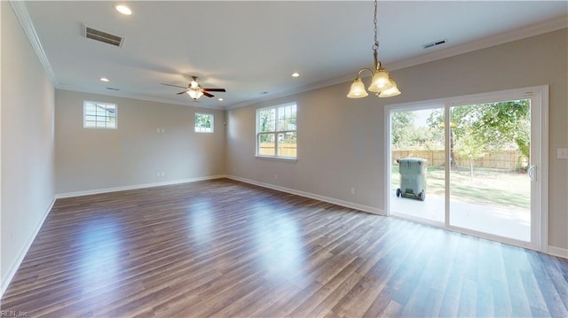 unfurnished room with visible vents, ornamental molding, baseboards, and wood finished floors