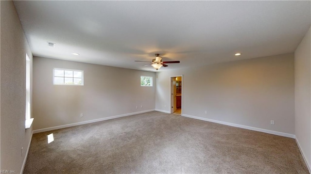 carpeted empty room featuring a ceiling fan, recessed lighting, baseboards, and visible vents