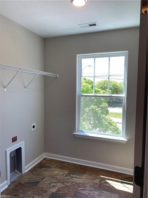 laundry area with laundry area, baseboards, visible vents, and hookup for an electric dryer