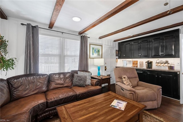 living area with beam ceiling and wood finished floors