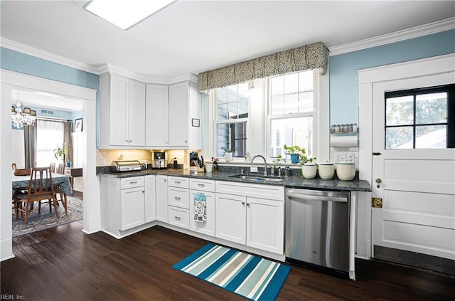 kitchen with dark wood-type flooring, ornamental molding, stainless steel dishwasher, a notable chandelier, and a sink