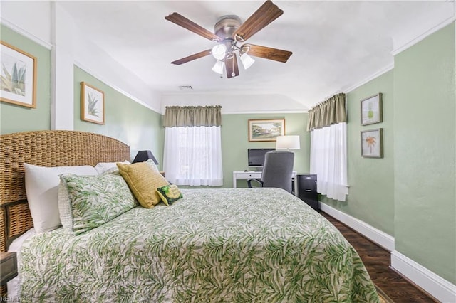 bedroom with a ceiling fan, visible vents, wood finished floors, baseboards, and ornamental molding