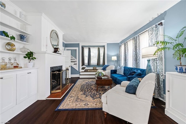 living area with dark wood finished floors and a fireplace