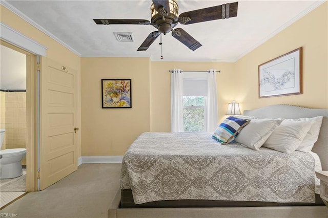 carpeted bedroom with visible vents, connected bathroom, baseboards, and ornamental molding