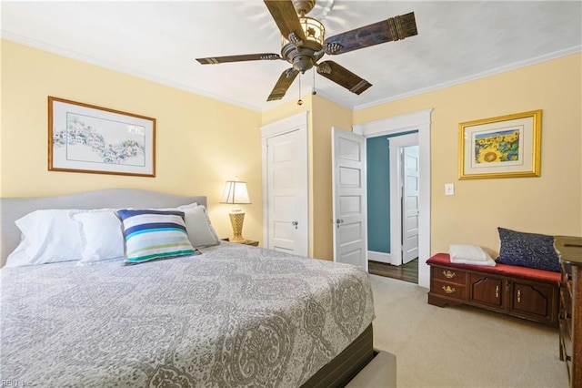 carpeted bedroom with crown molding and a ceiling fan