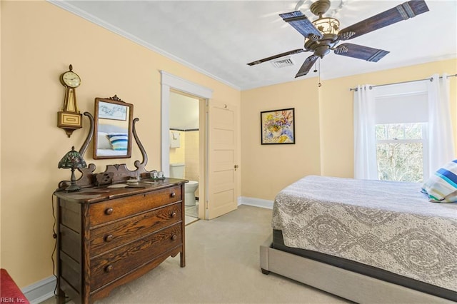 bedroom with visible vents, baseboards, ornamental molding, ensuite bathroom, and light colored carpet