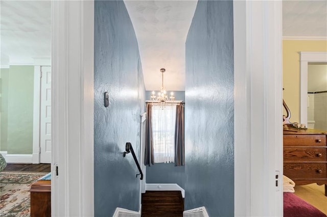 stairway with baseboards, an inviting chandelier, and ornamental molding