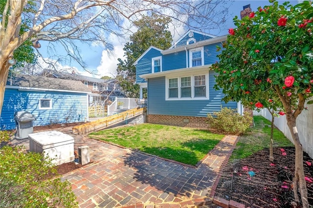 exterior space with a lawn and fence