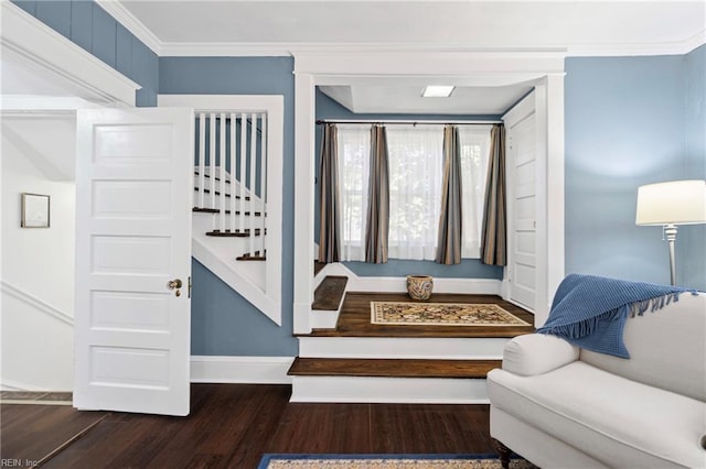 entrance foyer featuring baseboards, wood finished floors, ornamental molding, and stairs