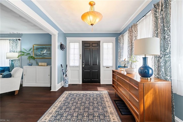 entrance foyer featuring baseboards, wood finished floors, and crown molding