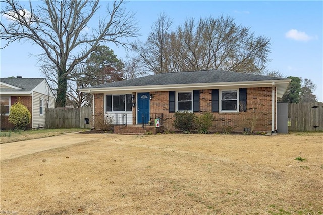 ranch-style house with brick siding, a front lawn, and fence