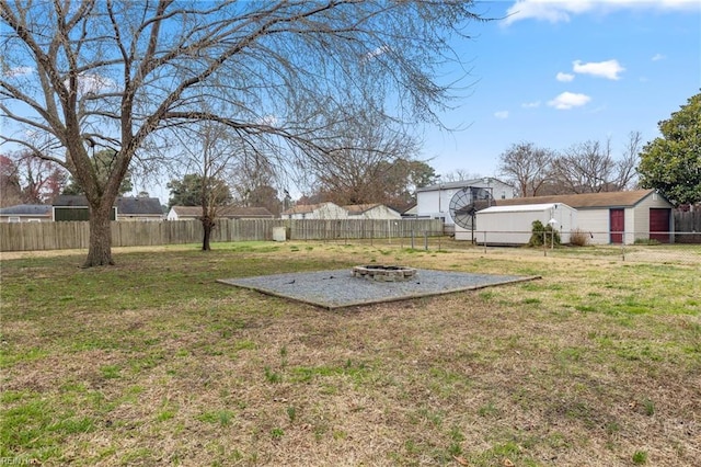 view of yard featuring a fire pit and a fenced backyard