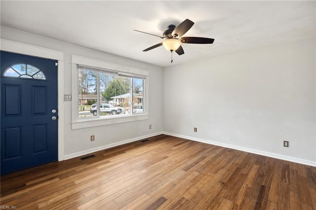 entrance foyer featuring a ceiling fan, wood finished floors, visible vents, and baseboards