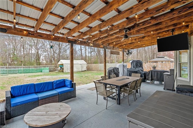 view of patio with outdoor dining space, a shed, a gazebo, an outdoor structure, and outdoor lounge area