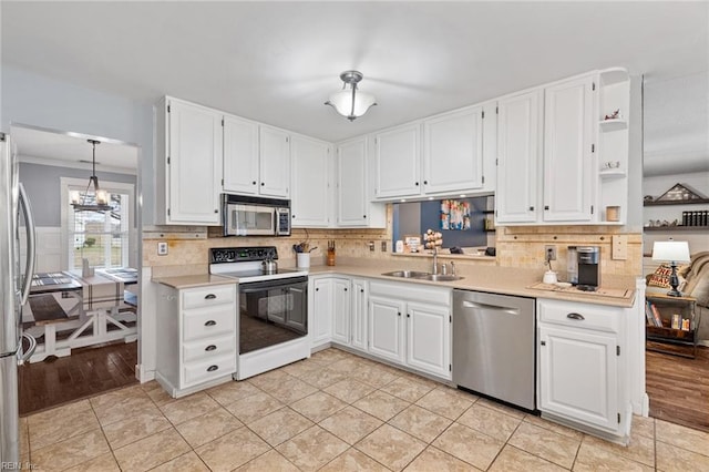 kitchen featuring a sink, stainless steel appliances, white cabinets, and light countertops