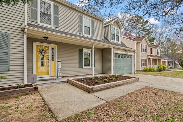 view of front of house with concrete driveway and an attached garage