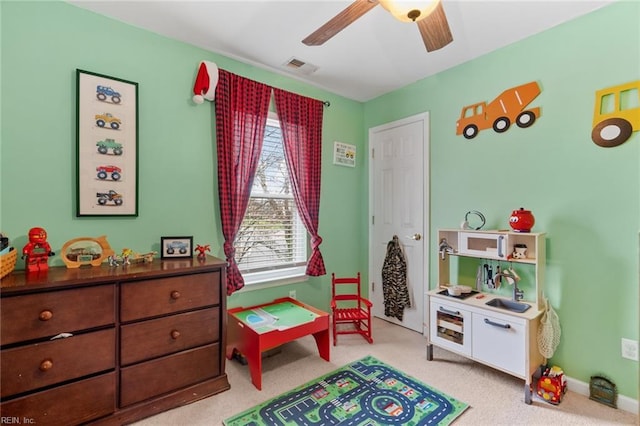 rec room with visible vents, baseboards, ceiling fan, and carpet floors