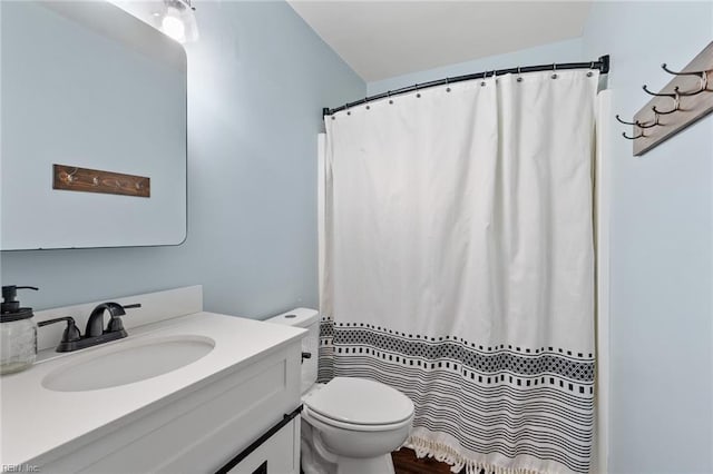 bathroom with vanity, toilet, and a shower with curtain