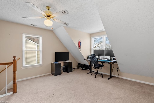 carpeted office featuring visible vents, a textured ceiling, baseboards, ceiling fan, and vaulted ceiling