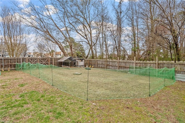 view of yard featuring an outdoor structure and a fenced backyard