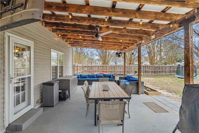 view of patio / terrace featuring an outdoor living space, a trampoline, and a fenced backyard