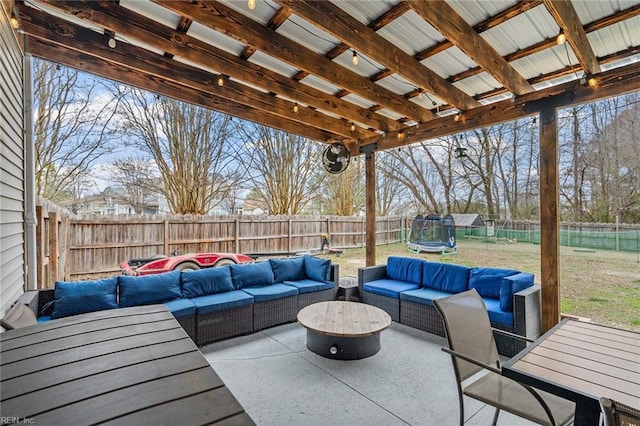 view of patio / terrace featuring a fenced backyard, an outdoor living space, and a trampoline