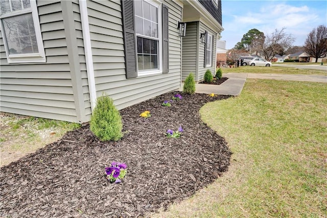 view of side of home featuring a yard