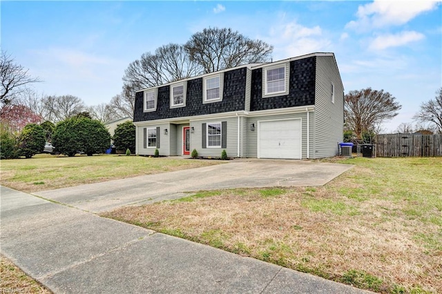 colonial inspired home with fence, a gambrel roof, concrete driveway, roof with shingles, and a front yard