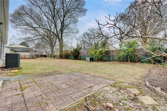 view of yard with central air condition unit, a fenced backyard, and a patio area