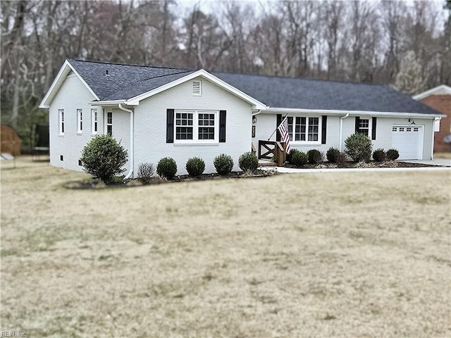 ranch-style house with a front lawn, brick siding, and a garage