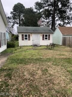 back of property with a lawn