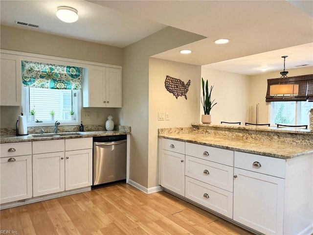 kitchen with visible vents, a sink, stainless steel dishwasher, light wood-style floors, and white cabinets