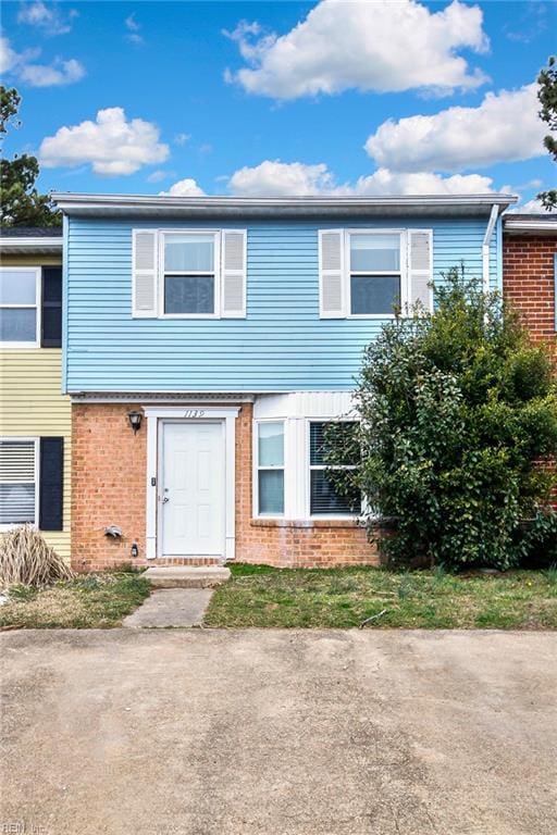 townhome / multi-family property with brick siding